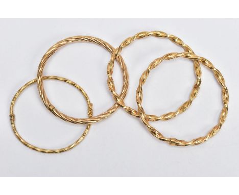 9CT GOLD AND YELLOW METAL BANGLES,  to include one twisted hinged hollow bangle, hallmarked 9ct gold Birmingham, two twisted 