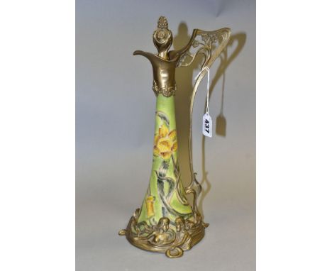 A REPRODUCTION ART NOUVEAU STYLE BRASS MOUNTED CERAMIC EWER, with foliate stopper, the wavy lip with scrolled lower rim, sinu