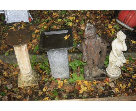 A COMPOSITE GARDEN ORNAMENT of a boy holding a jug lent against a fence 78cm, a composite semi-clad women, height 70cm, a com