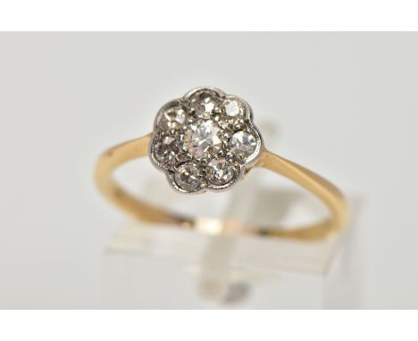 A YELLOW METAL DIAMOND CLUSTER RING, the cluster of a flower shape, set with eight old cut diamonds, total estimated diamond 