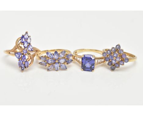 THREE 9CT GOLD TANZANITE RINGS AND ONE SIMULATED TANZANITE 14CT GOLD RING, sixteen stone tanzanite cluster ring, prong set wi