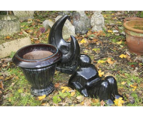 TWO BLACK GLAZED GARDEN ORNAMENTS together with a similar circular planter (3)