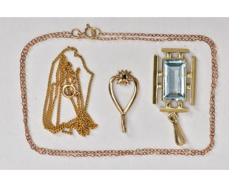 A 9CT GOLD TOPAZ PENDANT, TWO YELLOW METAL CHAINS AND A YELLOW METAL PENDANT, the first pendant of an art deco style mounted 