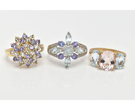 THREE 9CT GOLD GEM SET RINGS, the first designed as a central oval rose quartz flanked by oval aquamarines, the second design