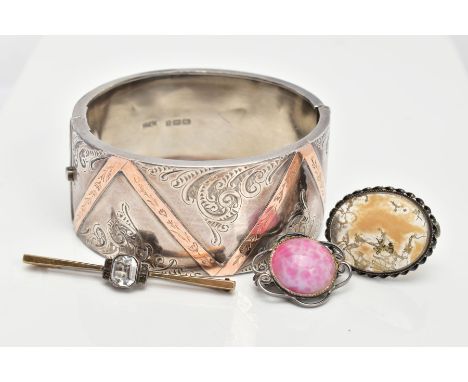 A SILVER HINGED BANGLE AND THREE BROOCHES, the wide hinged bangle, decorated with a foliate design and rose gold detail, fitt