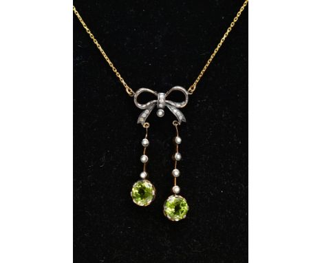 A YELLOW METAL PERIDOT AND SEED PEARL PENDANT NECKLACE, the pendant of a bow shape set with single cut diamonds, suspending t