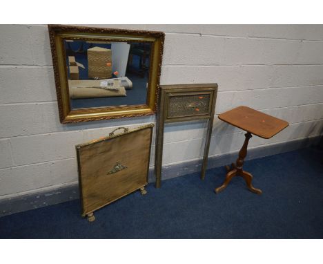 A FOLIATE GILTWOOD FRAMED BEVELLED EDGE MIRROR, 70cm x 60cm, a brass fire place, 54cm x 92cm, a brass fire screen and a walnu