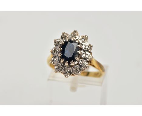 AN 18CT GOLD SAPPHIRE AND DIAMOND CLUSTER RING, designed with a central oval cut blue sapphire, within a single cut diamond d