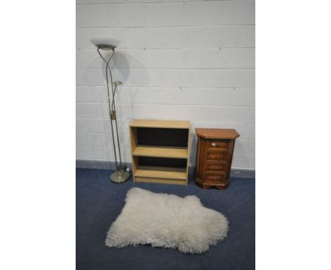 A SMALL CHERRYWOOD CHEST OF FOUR DRAWERS, with canted front corners, a sheep wool rug, open bookcase and a chrome standard la