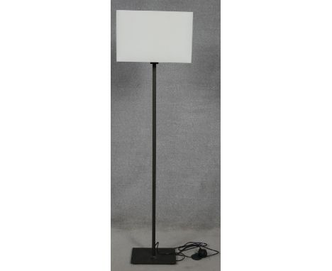 A contemporary standard lamp with silk faced shade. H.150cm 