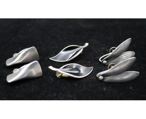 Three pairs of Danish silver clip earrings. One pair of black enamel Norwegian leaf earrings by designer David Andersen, a pa