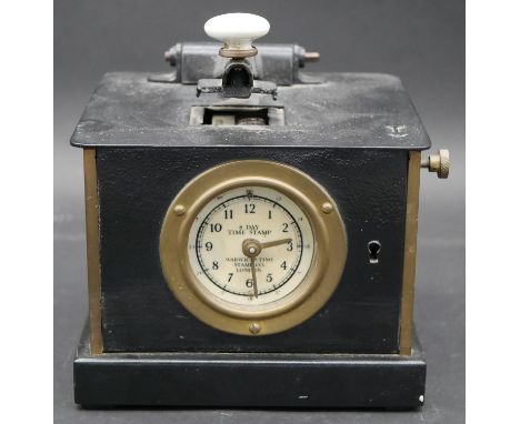 A C.1900 mechanical time recorder machine marked 8 day time stamp to the clock face, by Warwicks Time Stamp Co London. H.21.5