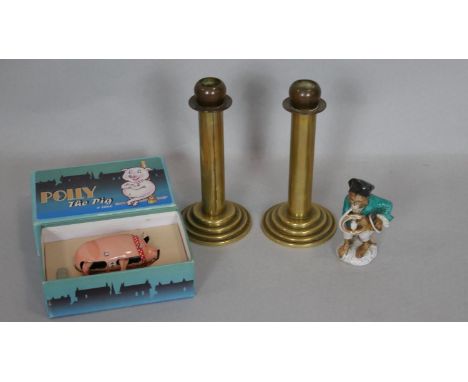 A pair of vintage brass candlesticks on stepped bases, a vintage boxed clockwork toy and a ceramic figure of a monkey playing