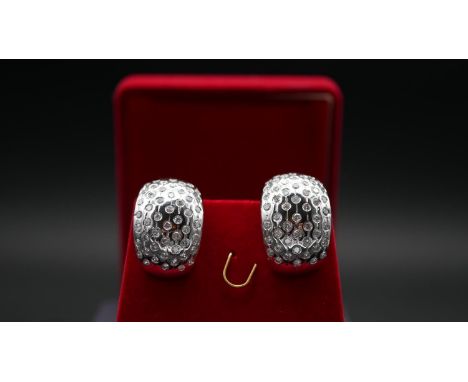 A red velvet boxed pair of half hoop white metal (tested 18 carat white gold) and diamond pierced earrings. Each earring set 