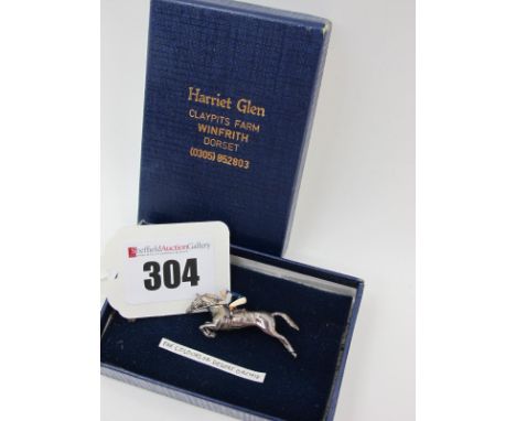 Harriet Glen; A Hallmarked Silver and Enamel Racing Horse and Jockey Brooch, the jockey highlighted in the colours of Desert 