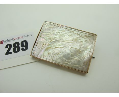 A Chinese Mother of Pearl Rectangular Panel Brooch, the front carved depicting figures and houses, the reverse with vacant ce