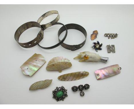 Vintage Bangles, mother of pearl brooches, claw brooch, further costume brooches. 