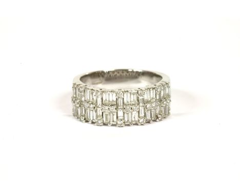 An 18ct white gold two row diamond band ring, set with baguette cut and brilliant cut diamonds, claw set to a plain polished 