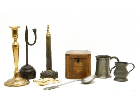 A group of brass candlesticks, together with a copper pan lid, a Georgian tea caddy, a rush light, a nutcracker formed as a p