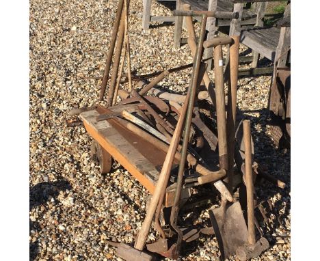 A collection of garden tools, and a cast iron trolley