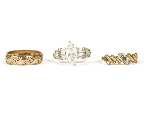 An American white gold curbic zirconia ring, with rows of tapered baguette shoulders on a polished band, marked 14k, 4.28g, a