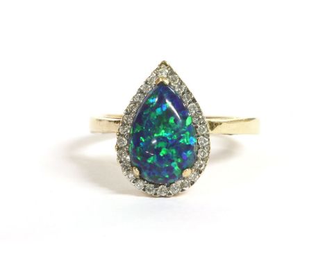 A gold pear shaped synthetic opal and diamond cluster ring, to a plain polished shank, marked 10k, 3.58g