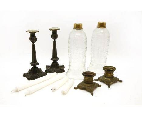 A pair of storm lights, with etched glass shades on bronze bases, 31cm high and a further pair of modern bronze candlesticks,