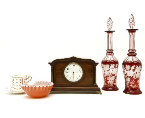 A pair of ruby flashed decanters, with grape and vine decoration, together with an Edwardian mantle clock, a coloured glass s