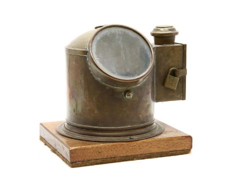 A brass cased nautical compass, on a teak plinth, 26cm x 26cm x 28cm