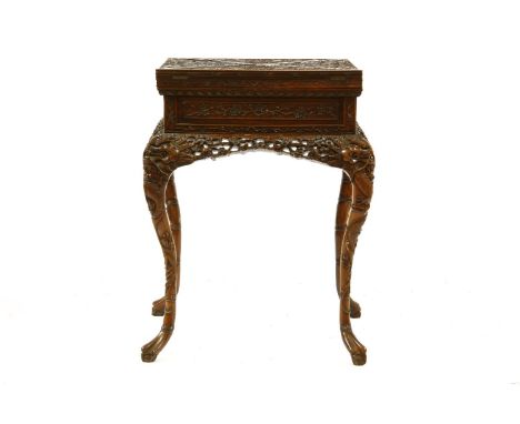 A Chinese envelope fold over card table, the relief carved top decorated with dragons amongst clouds over single drawer and p