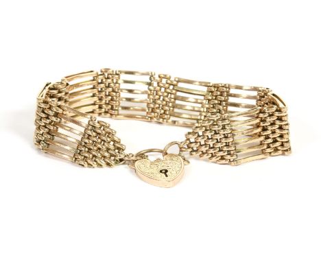 A gold six row gate link bracelet, with padlock, marked 9ct gold, 23.56g