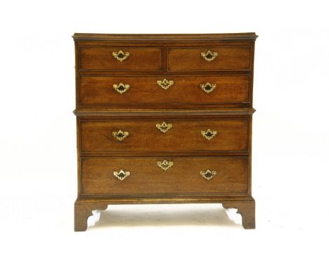 A Georgian oak campaign style chest of two short over three long drawers, on bracket feet