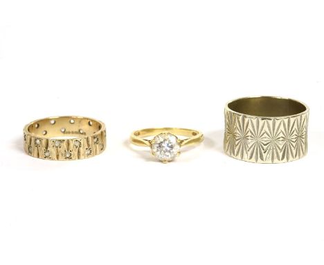 A 9ct gold wedding ring, bark textured set decoration with synthetic spinels, 3.83g, a 9ct white gold wedding ring, with diam