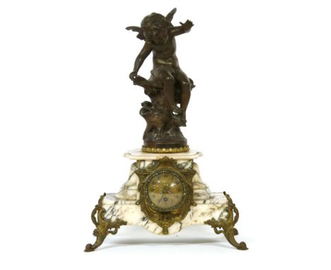 A marble and metal mounted gilt mantel clock, with a spelter figure, 52cm high
