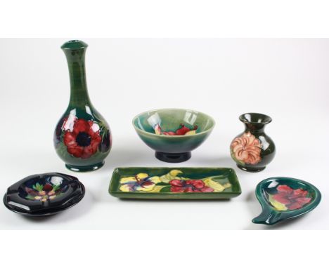 Moorcroft. Seven pieces of Moorcroft comprising three dishes, bowl, lamp base, vase & ashtray, small chip to ashtray