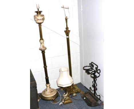 A brass Corinthian columnar standard lamp; a similar table lamp; a brass and pottery standard lamp; and a stick stand 