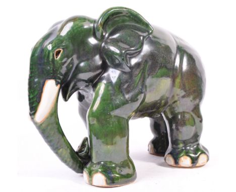 Yare Studio (believed) - An original retro vintage 1970's green glaze monochrome ceramic figurine of an elephant. The elephan