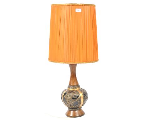 A mid century teak wood and metal banded table lamp of large form having a bulbous base with teak wood bottom having unusual 