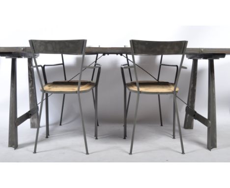 A modernist Industrial revival 21st century dining room suite. The suite comprising a wooden planked strapped metal refectory
