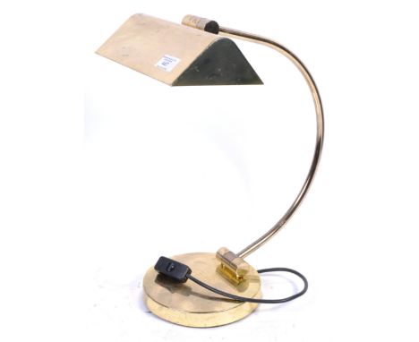 A 1970's Italian retro brass plated bankers desk lamp of angular form. Raised on a circular plinth base having a c-scroll arm