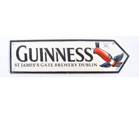 Guinness - A contemporary replica decorative cast iron shop / advertising type Guinness sign. The painted sign in relief of a
