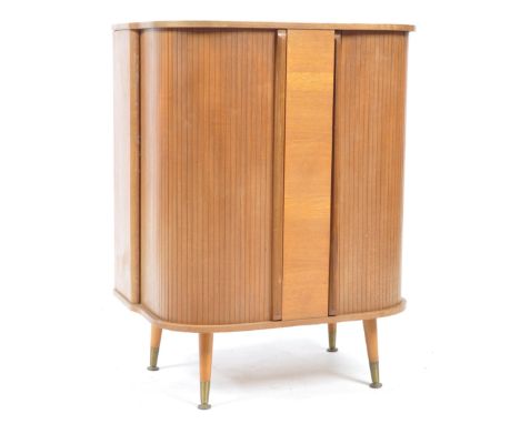 A mid century teak wood tambour fronted drinks / cocktail pedestal cabinet. Raised on tapering legs with brass cap castors. A