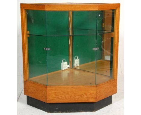 A 1930's Art Deco small proportioned Industrial shop haberdashery corner counter cabinet. The oak body with plinth base havin