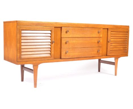 An original retro vintage 1970's teak wood sideboard credenza of low form having square pull handles. The sideboard raised on