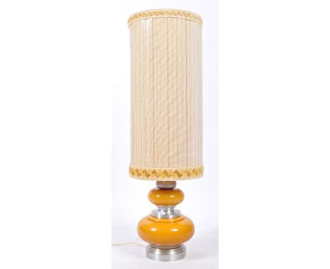 A mid century polished aluminium and amber / orange glass table lamp of large form having bulbous glass base with polished al