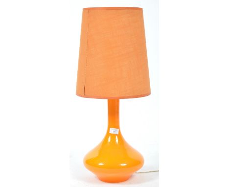 A mid century retro amber / orange glass table lamp of large form having bulbous glass base with the original tapering cylind