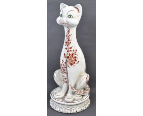 A mid 20th century Italian art pottery / ceramic cat of elongated form raised on a plinth base with floral transfer printed d