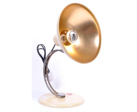 A retro mid century space age desk lamp by Cardinal. The terraced base with c-scroll chrome arm having ufo shaped shade and c