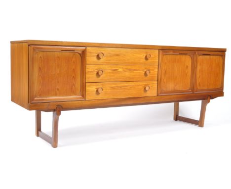 A 20th century Danish influenced retro teak wood credenza sideboard having a bank of three graduating drawers flanked by two 