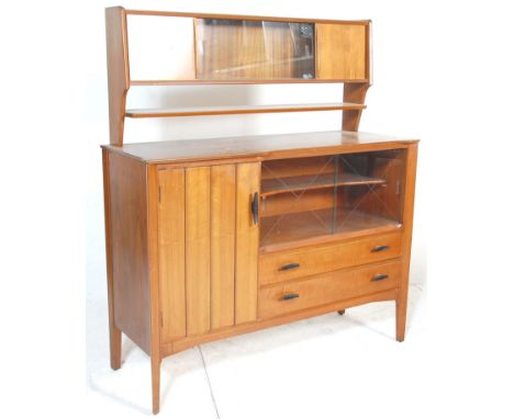 A retro British mid 20th century design teak wood sideboard credenza. The base being raised on shaped supports having a serie